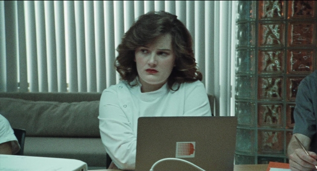 Wide shot frame from A Different Man — sitting, table, couch