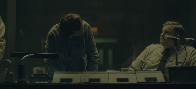 Wide shot frame from Joker: Folie à Deux — people, sitting, action