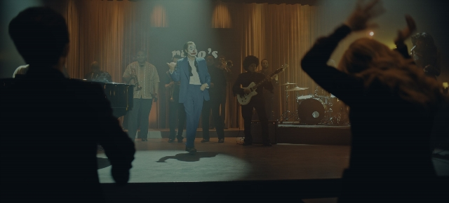 Wide shot frame from Joker: Folie à Deux — standing, suit, tie