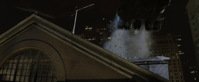 Wide shot frame from Batman Begins — night, snow, fountain