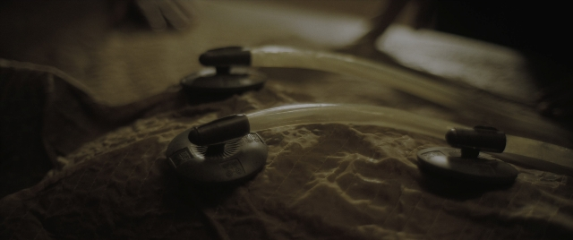 Wide shot frame from Dune: Part Two — bed, headphones
