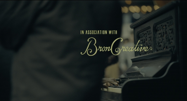 Wide shot frame from Joker — room, piano, person