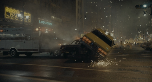 Wide shot frame from Joker — walking, street, car