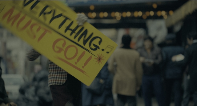 Wide shot frame from Joker — standing, street, shirt