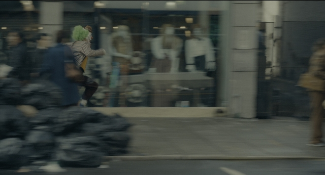 Wide shot frame from Joker — standing, walking, street