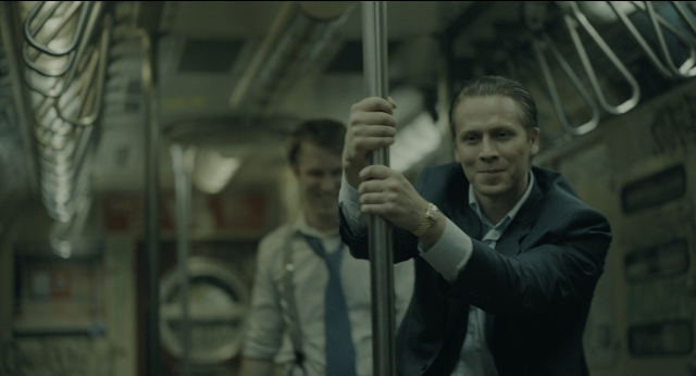 Wide shot frame from Joker — suit, tie, shirt