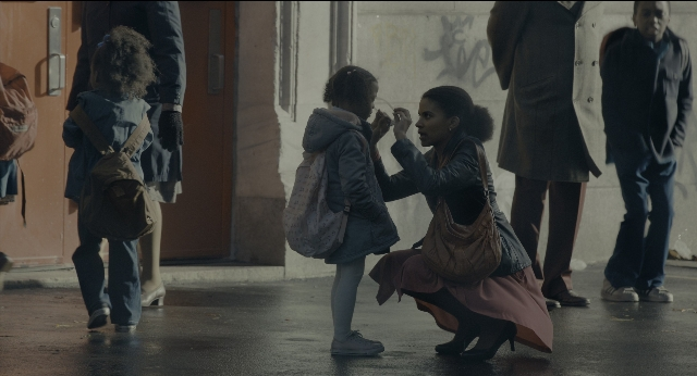 Wide shot frame from Joker — walking, dialogue, street
