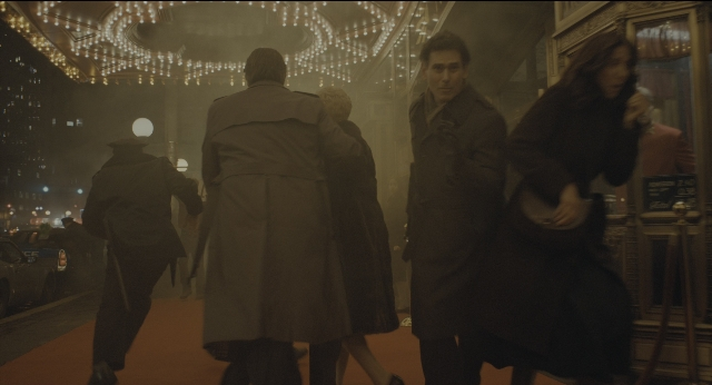 Wide shot frame from Joker — walking, street, coat