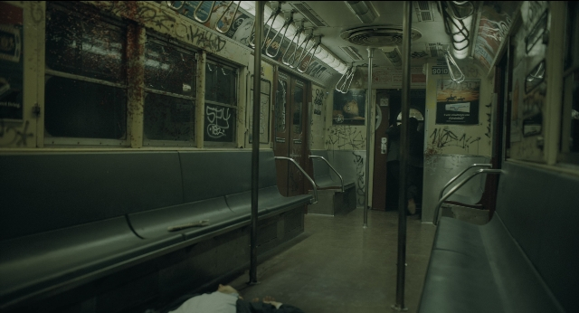 Medium shot frame from Joker — standing, train, person