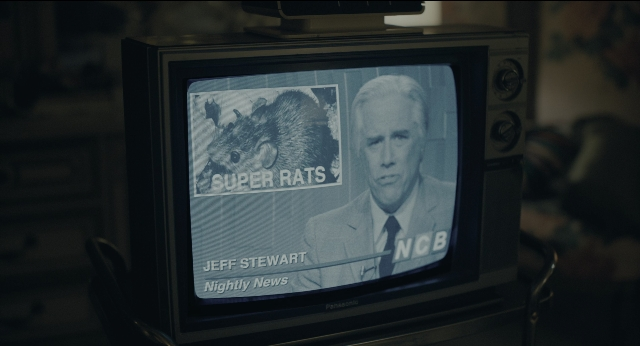 Wide shot frame from Joker — room, suit, tie