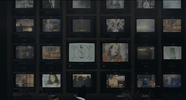 Wide shot frame from Joker — sitting, standing, walking