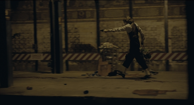 Wide shot frame from Joker — walking, street, night