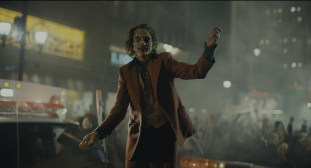 Wide shot frame from Joker — standing, street, suit