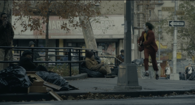 Wide shot frame from Joker — sitting, standing, walking
