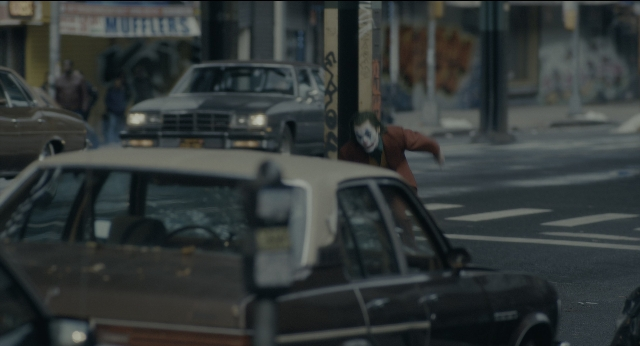 Wide shot frame from Joker — standing, walking, street