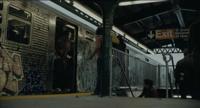 Wide shot frame from Joker — standing, train, person
