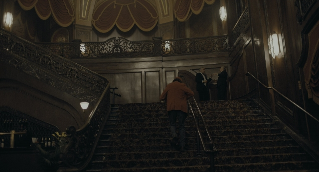 Wide shot frame from Joker — standing, walking, room