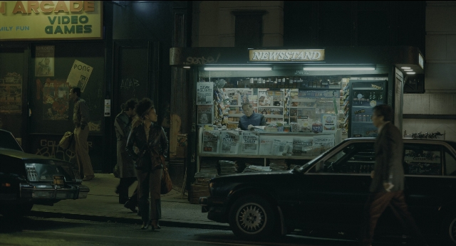 Wide shot frame from Joker — sitting, walking, table