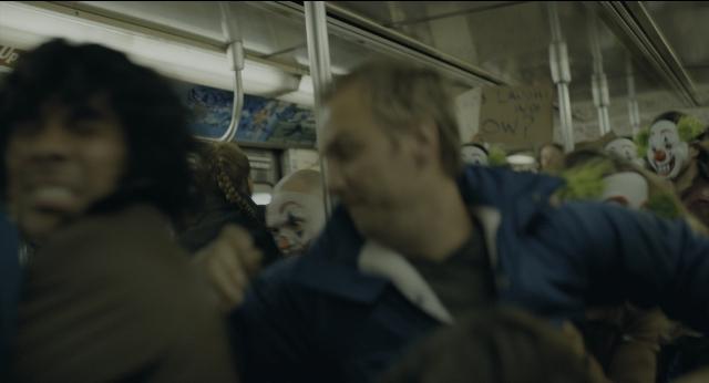 Wide shot frame from Joker — dialogue, train, person