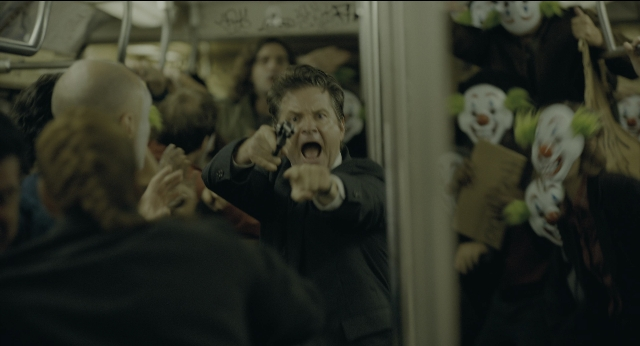 Wide shot frame from Joker — standing, hand, suit