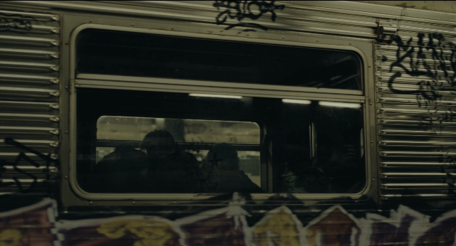 Wide shot frame from Joker — car, glass, train