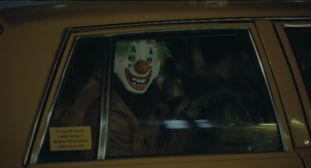 Wide shot frame from Joker — car, night, face