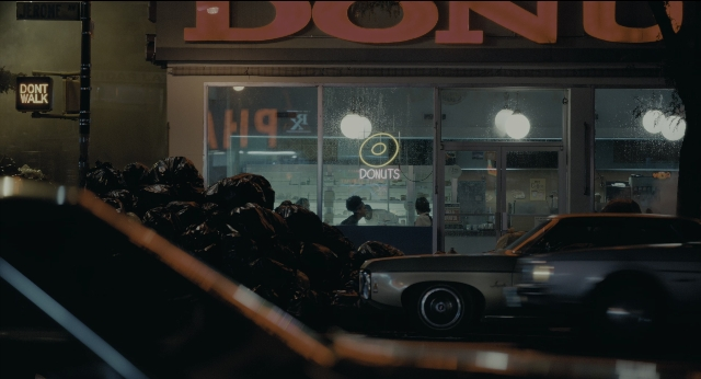 Wide shot frame from Joker — street, car, night