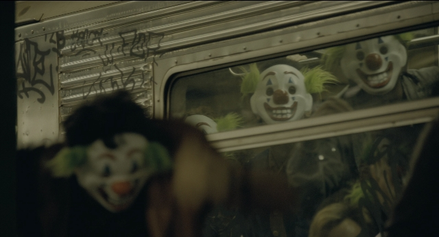 Wide shot frame from Joker — hand, face, hair