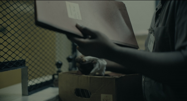 Wide shot frame from Joker — room, hand, shirt