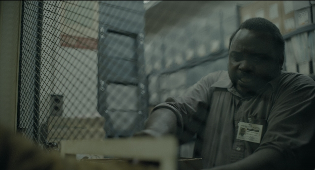 Wide shot frame from Joker — sitting, room, table