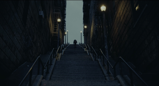 Wide shot frame from Joker — walking, street, night