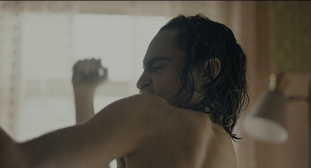 Frame from Joker — standing, face, hair