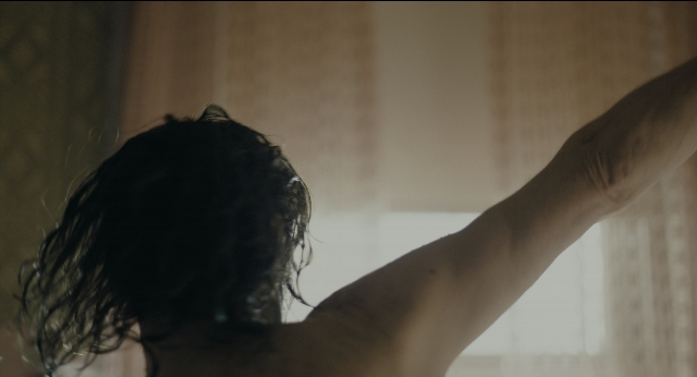 Wide shot frame from Joker — room, hair, person