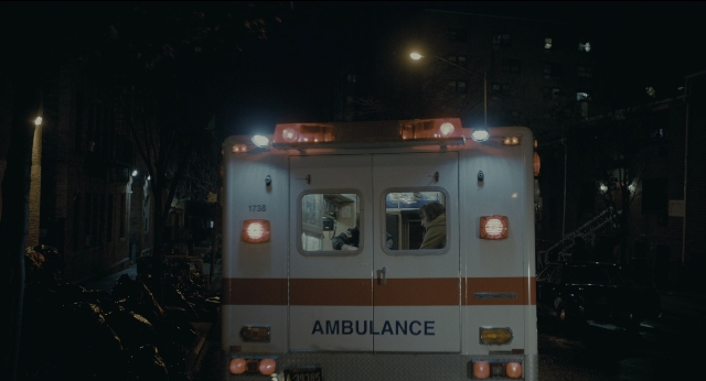 Wide shot frame from Joker — street, night, land vehicle