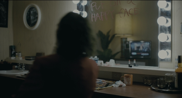 Frame from Joker — sitting, desk, room