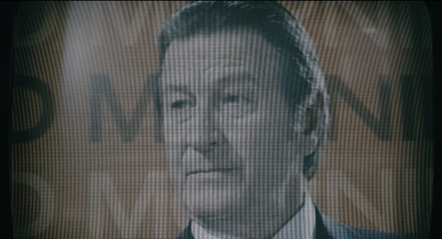 Frame from Joker — room, suit, tie