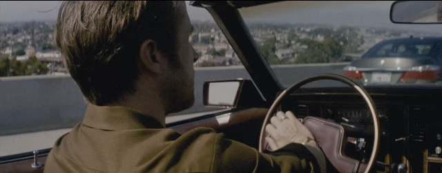 Wide shot frame from La La Land — sitting, street, mirror