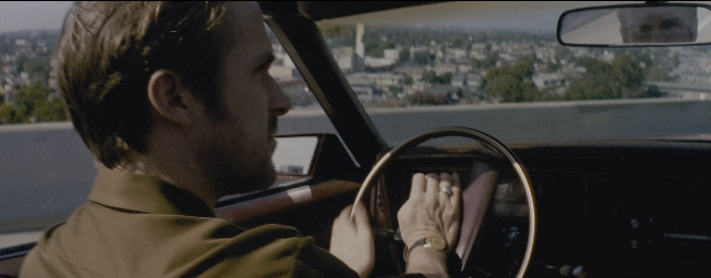 Wide shot frame from La La Land — sitting, mirror, car
