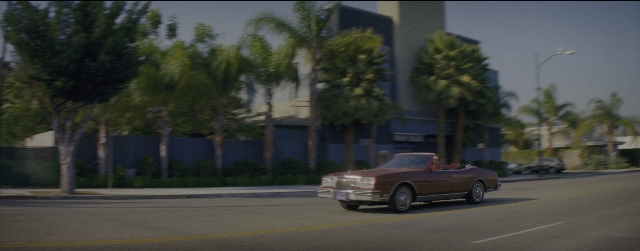 Wide shot frame from La La Land — street, car, lamp