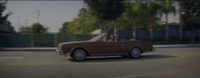 Wide shot frame from La La Land — street, car, wheel