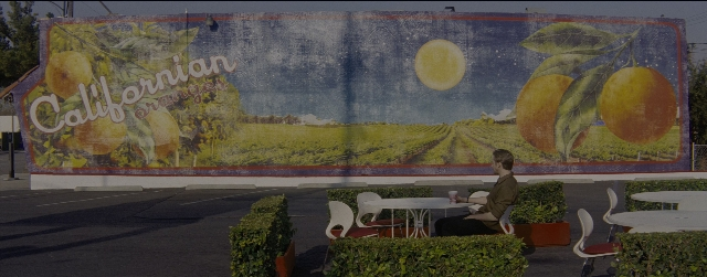 Wide shot frame from La La Land — sitting, table, chair