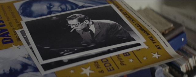 Wide shot frame from La La Land — suit, tie, face