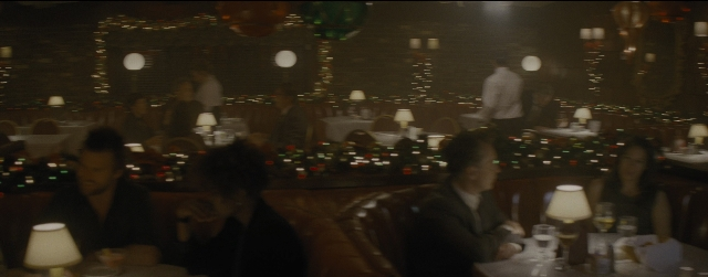 Wide shot frame from La La Land — sitting, room, dialogue