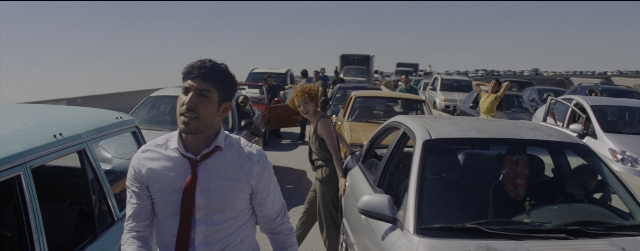 Wide shot frame from La La Land — standing, walking, car