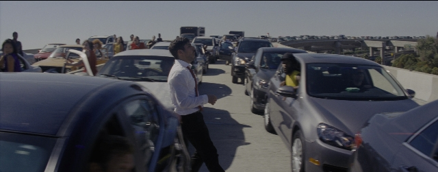 Wide shot frame from La La Land — standing, walking, street