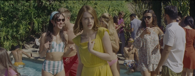 Wide shot frame from La La Land — sitting, standing, hand