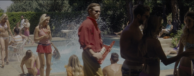 Wide shot frame from La La Land — sitting, book, standing