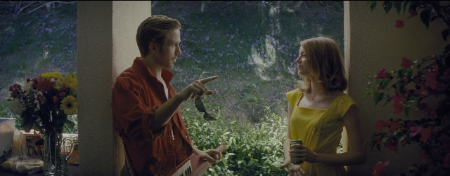 Wide shot frame from La La Land — standing, hand, dress