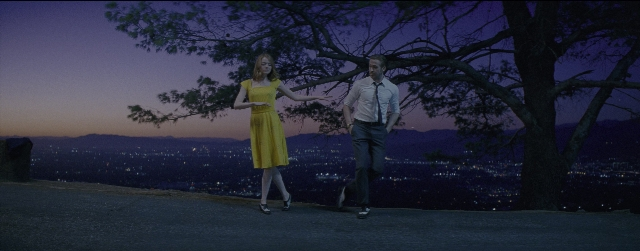 Wide shot frame from La La Land — standing, night, dress