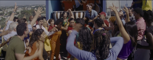 Wide shot frame from La La Land — sitting, standing, chair